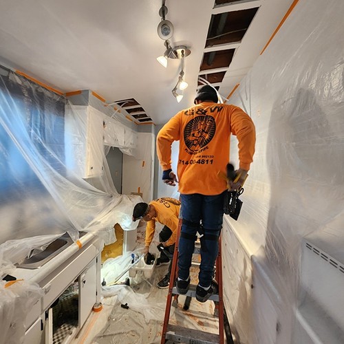 G & W Plumbing & Repipe team discussing a project